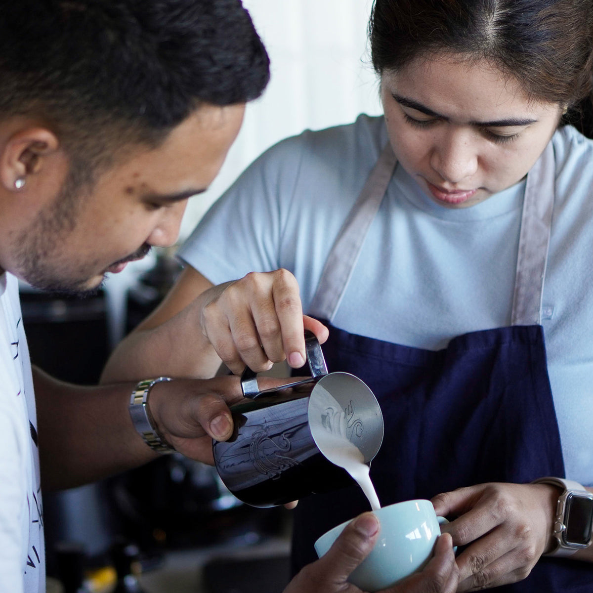 Participant learning coffee preparation in a Brewing Club class